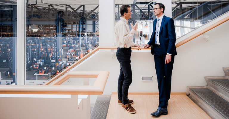 Sales people talking in hallway